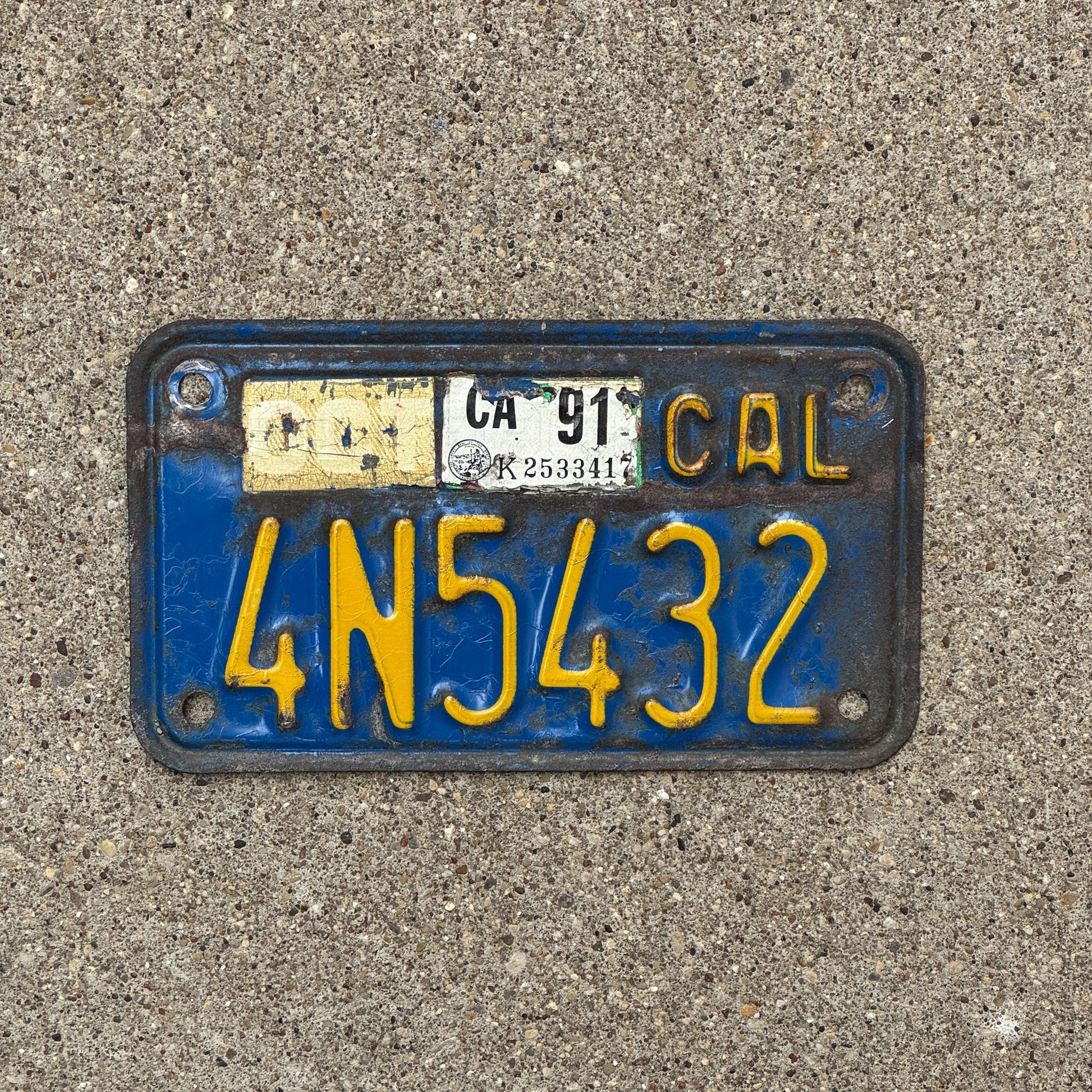 Photo of a 1970 1991 California Motorcycle License Plate Auto Tag Garage Decor Vintage 4N5432 with original patina
