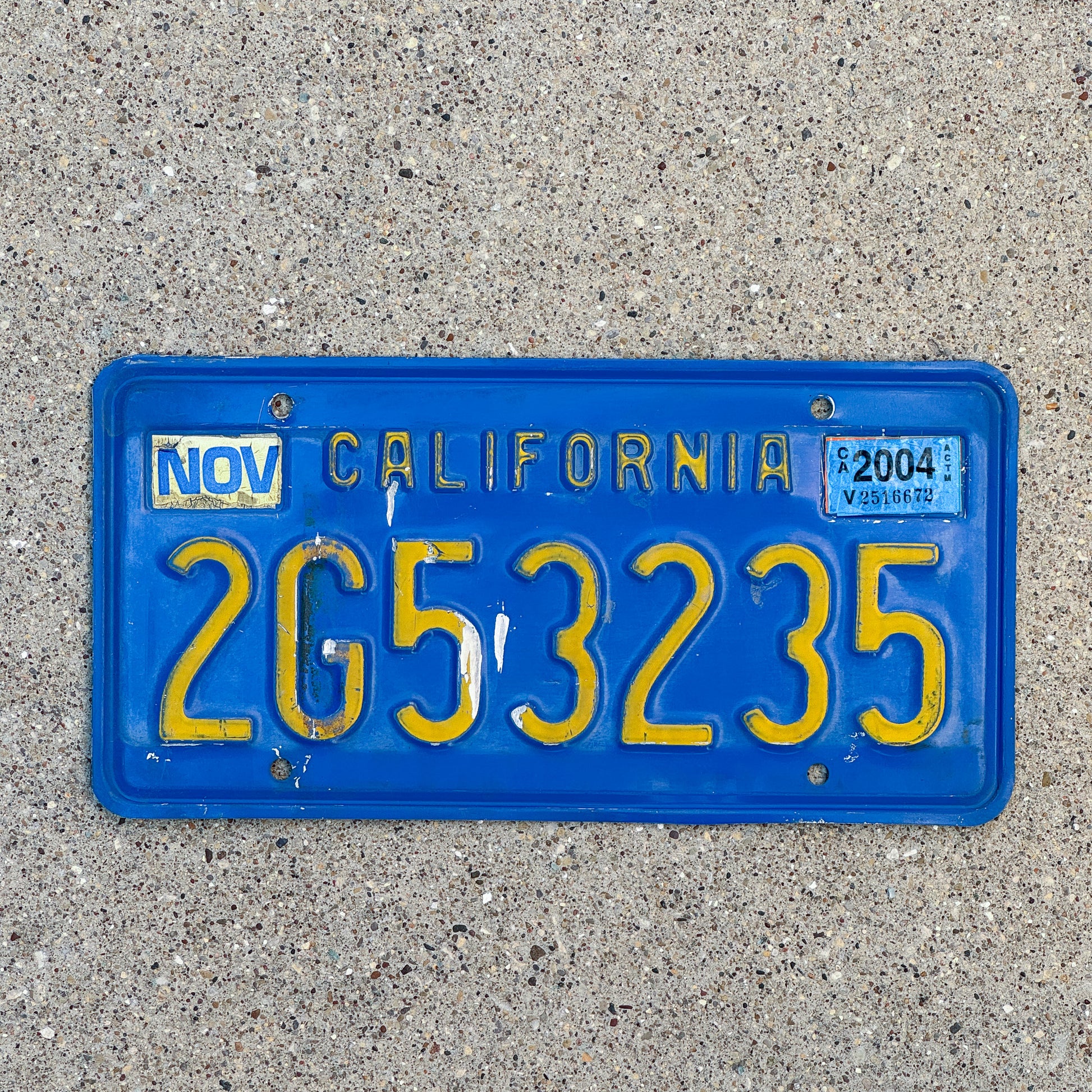 Photo of a 1970 2004 California Commercial License Plate Auto Tag Garage Decor Vintage 2G53235 with original patina