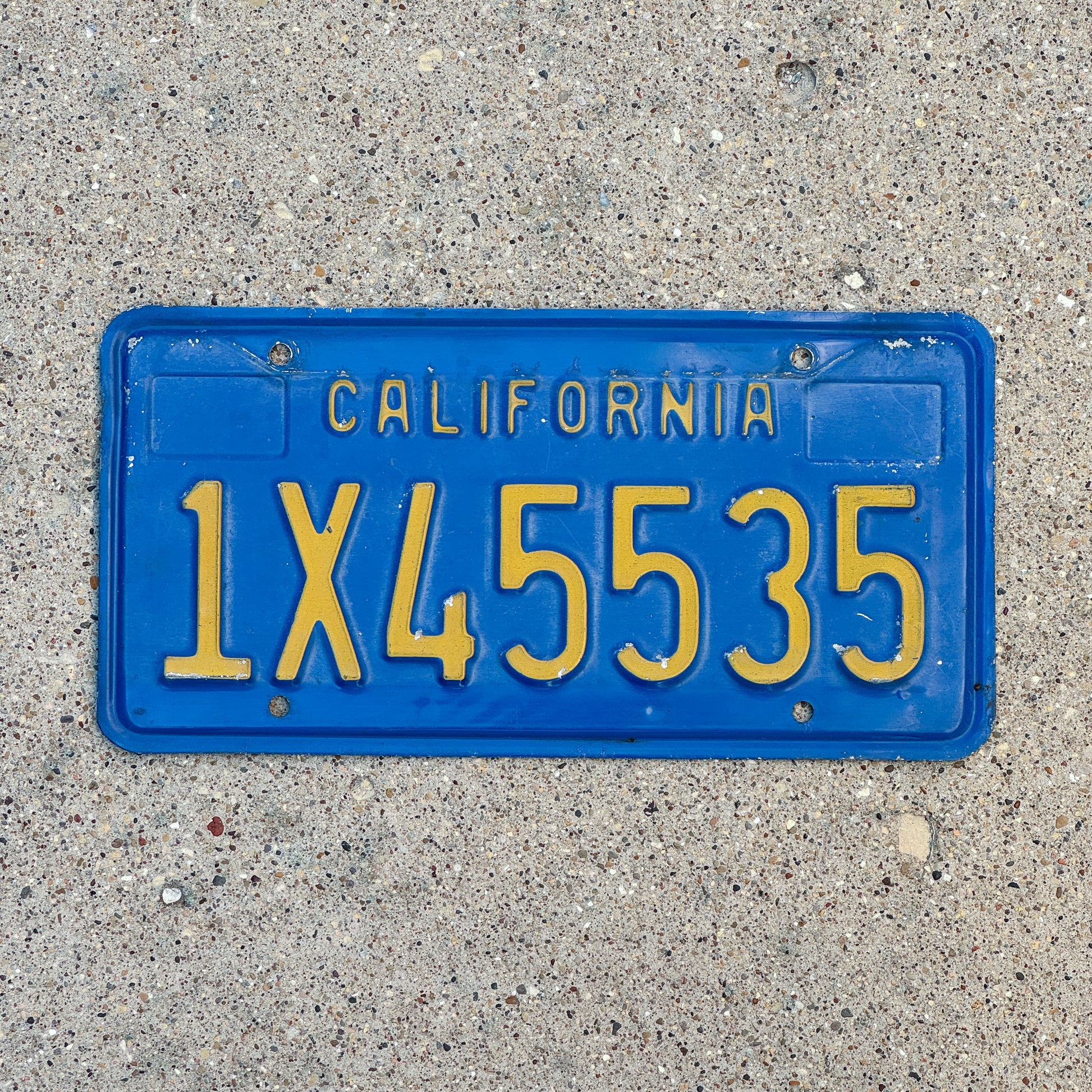 Photo of a 1970 California Commercial License Plate Auto Tag Garage Decor Vintage 1X45535 with original patina