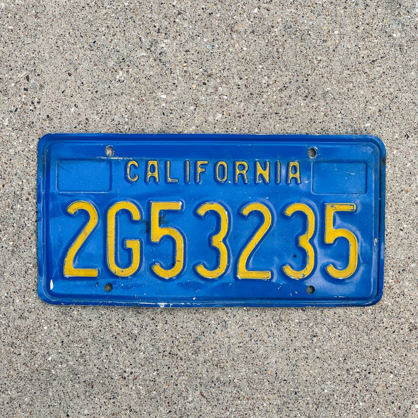 Photo of a 1970 California Commercial License Plate Auto Tag Garage Decor Vintage 2G53235 with original patina