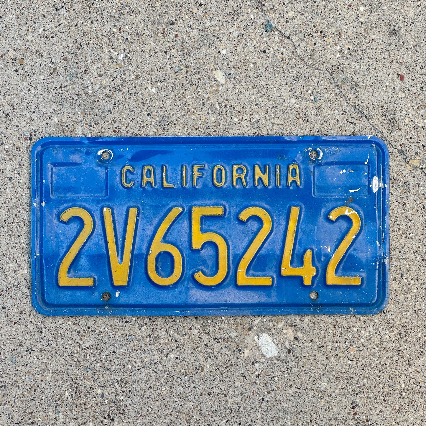Photo of a 1970 California Commercial License Plate Auto Tag Garage Decor Vintage 2V65242 with original patina