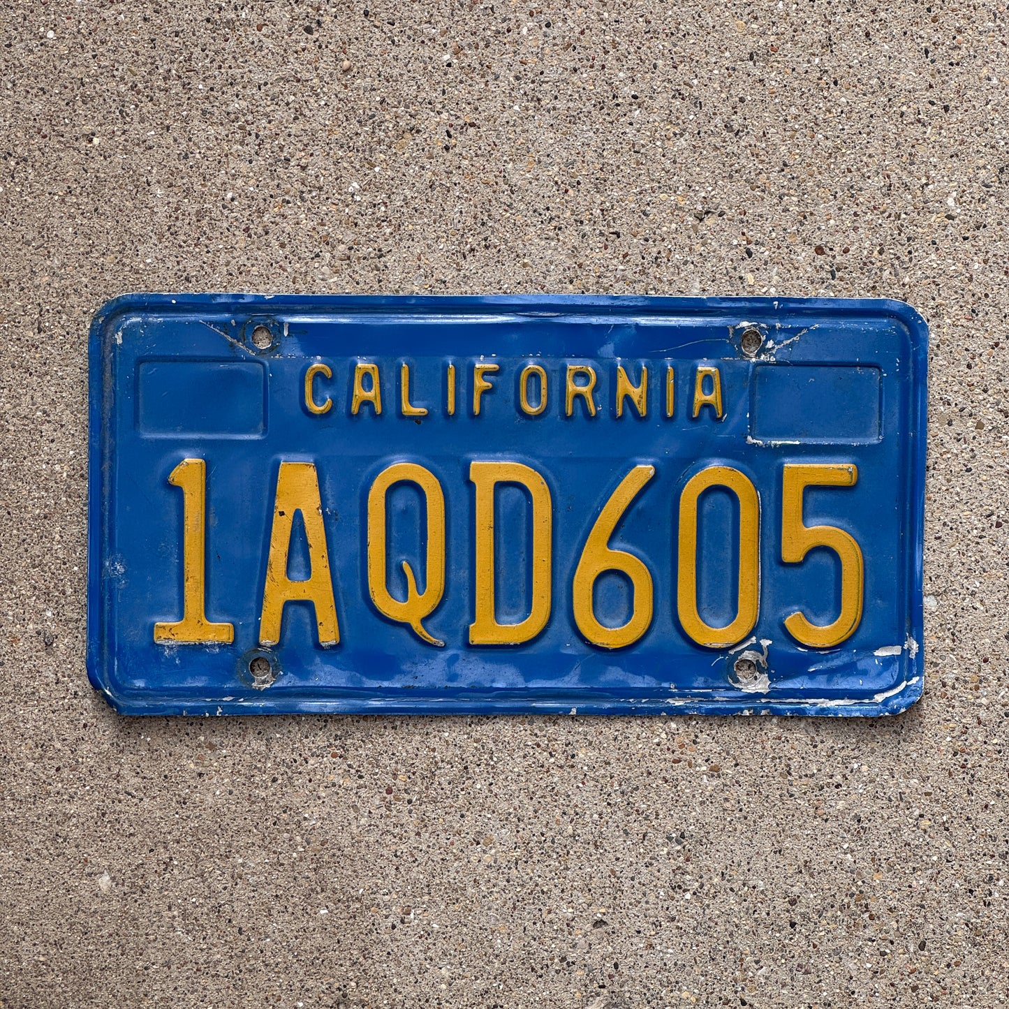 Photo of a 1970 California License Plate Auto Tag Garage Decor Vintage 1 AQD 605 with original patina