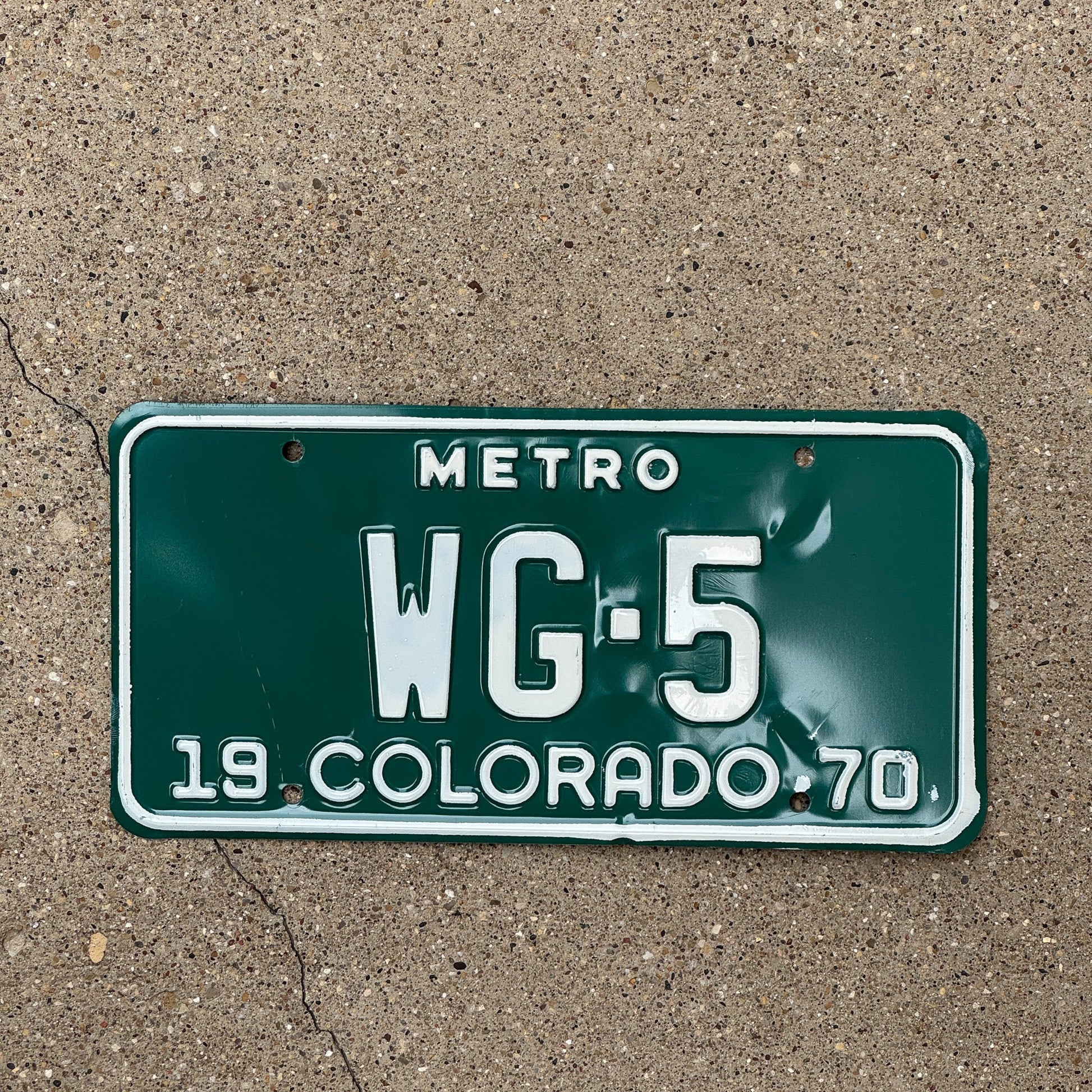 Photo of a 1970 Colorado Metro License Plate Auto Tag Garage Decor Vintage WG 5