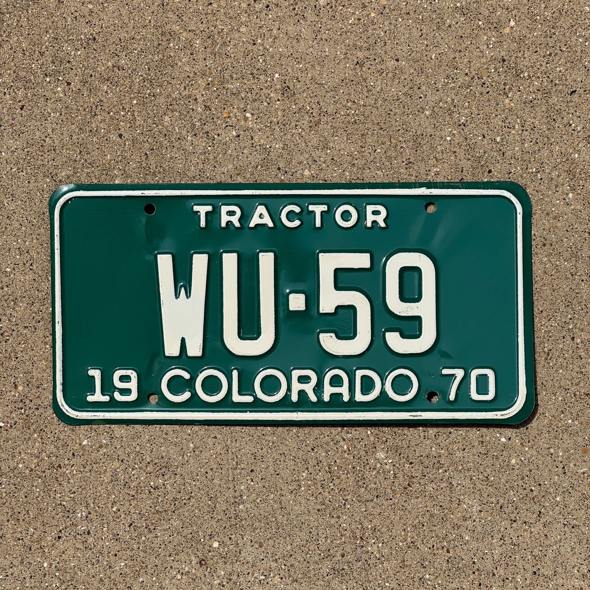Photo of a 1970 Colorado Tractor License Plate Auto Tag Garage Decor Vintage WU 59