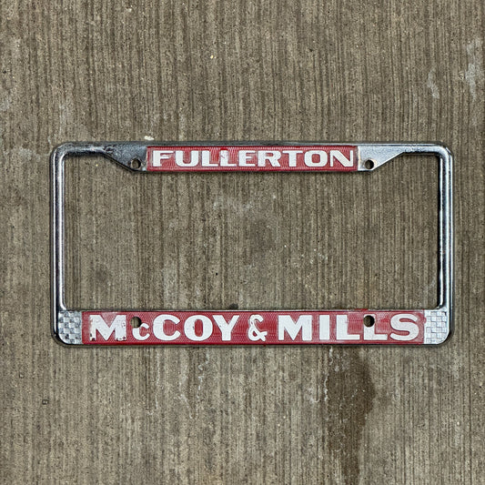 Photo of a 1970 Era California License Plate Frame Auto Tag 2 Vintage Garage Fullerton Metal McCoy & Mills Ford Dealer with original patina