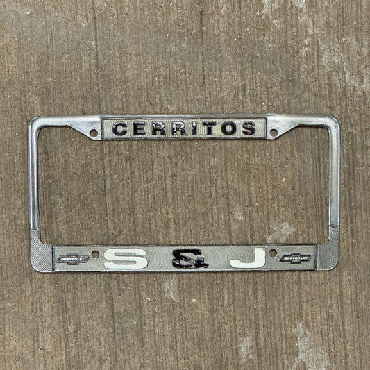 Photo of a 1970 Era California License Plate Frame Auto Tag Garage Decor Vintage Cerritos Metal S & J Chevy with original patina