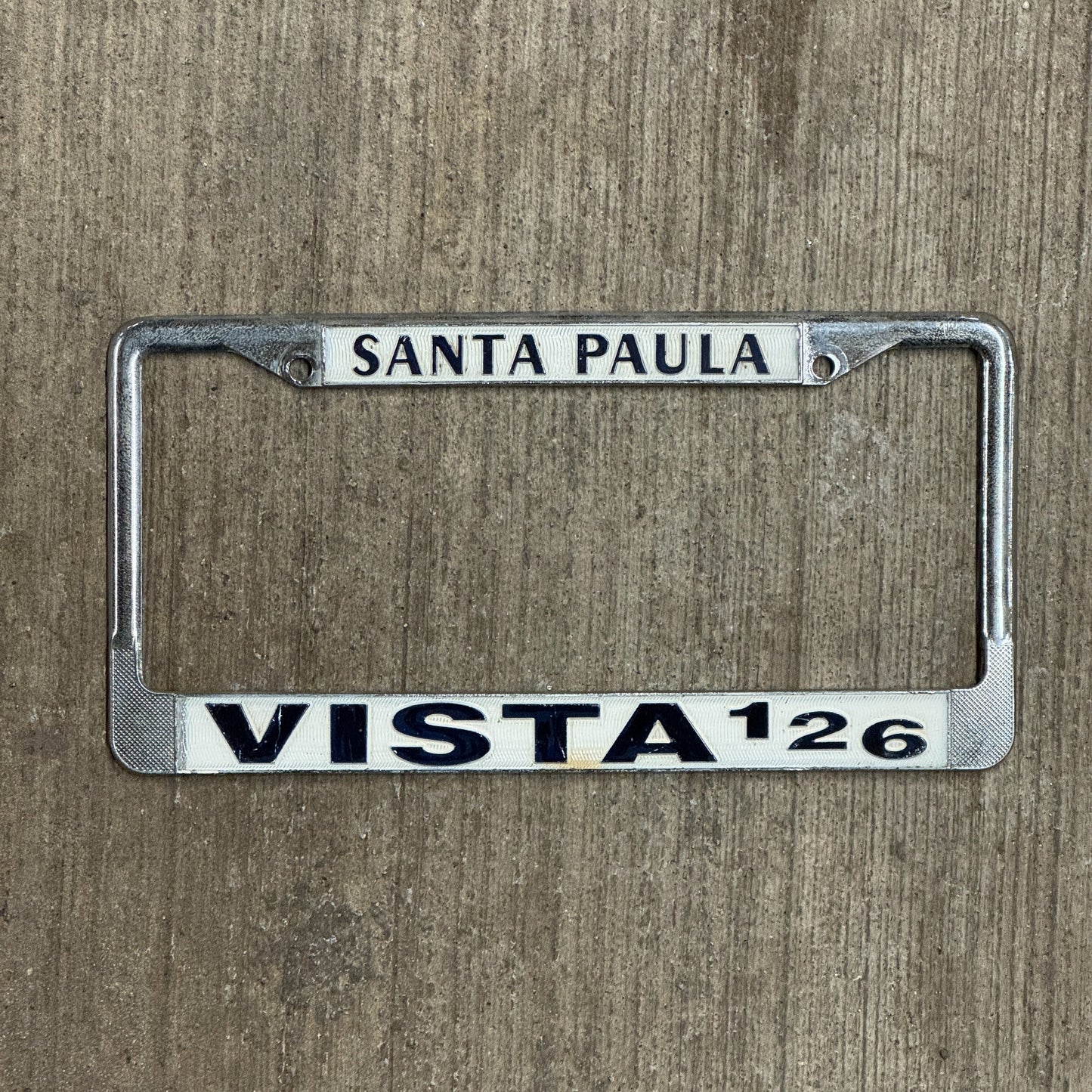 Photo of a 1970 Era California License Plate Frame Auto Tag Garage Decor Vintage Ford Metal Santa Paula Vista 126 with original patina