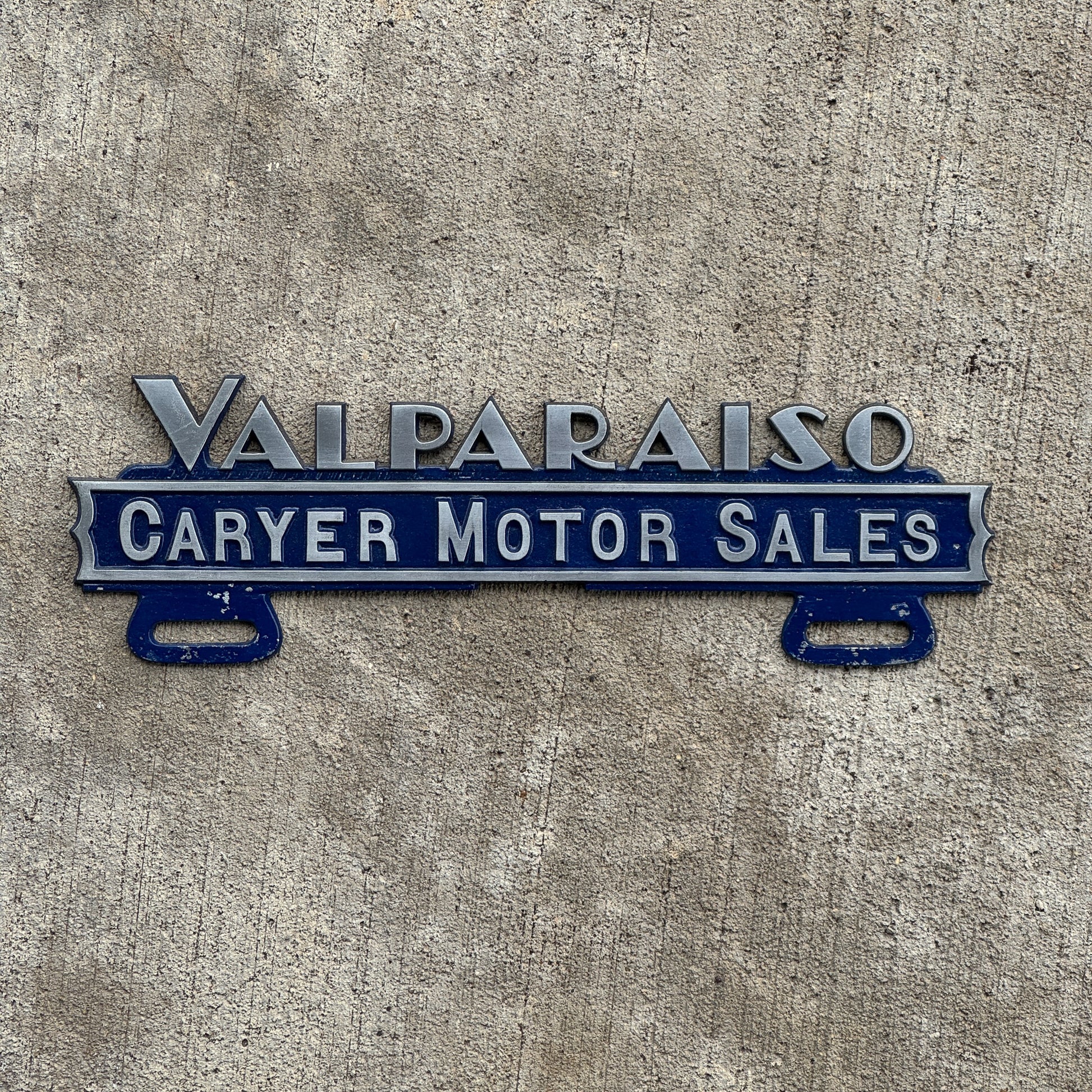 Photo of a 1970 Era Caryer Motor Sales Valparaiso Indiana License Plate Topper Auto Tag Garage Decor Vintage Cast Aluminum Desoto Plymouth with original patina