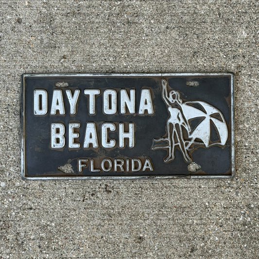 Photo of a 1970 Era Daytona Beach Florida Booster License Plate Auto Tag Garage Decor Vintage
 Embossed Plastic with original patina