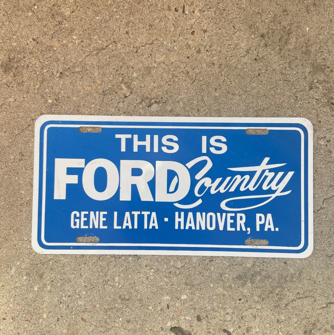 Photo of a 1970 Era Hanover Pennsylvania Booster License Plate Auto Tag Garage Decor Vintage Metal Booster Plate Ford Dealer with original patina