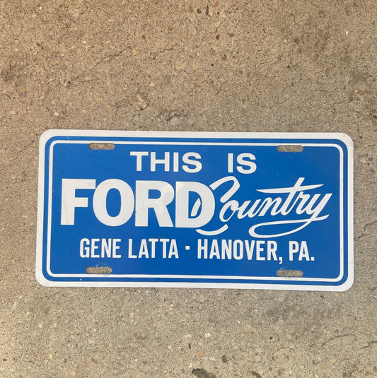 Photo of a 1970 Era Hanover Pennsylvania Booster License Plate Auto Tag Garage Decor Vintage Metal Booster Plate Ford Dealer with original patina