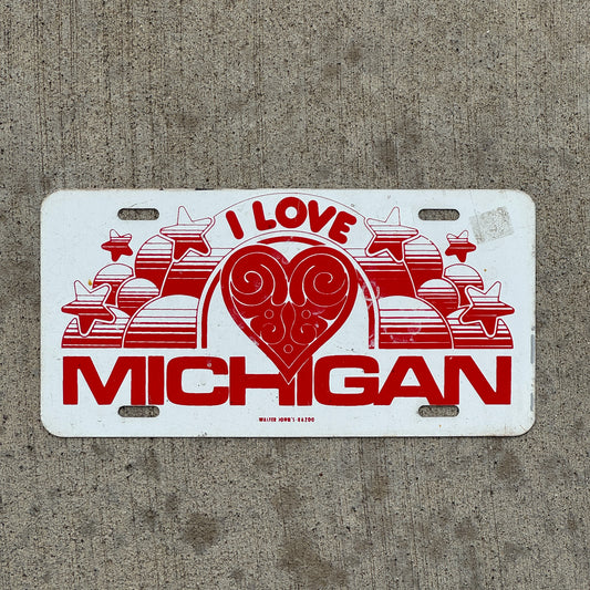 Photo of a 1970 Era I Love Michigan Booster License Plate Auto Tag Garage Decor Vintage Metal with original patina