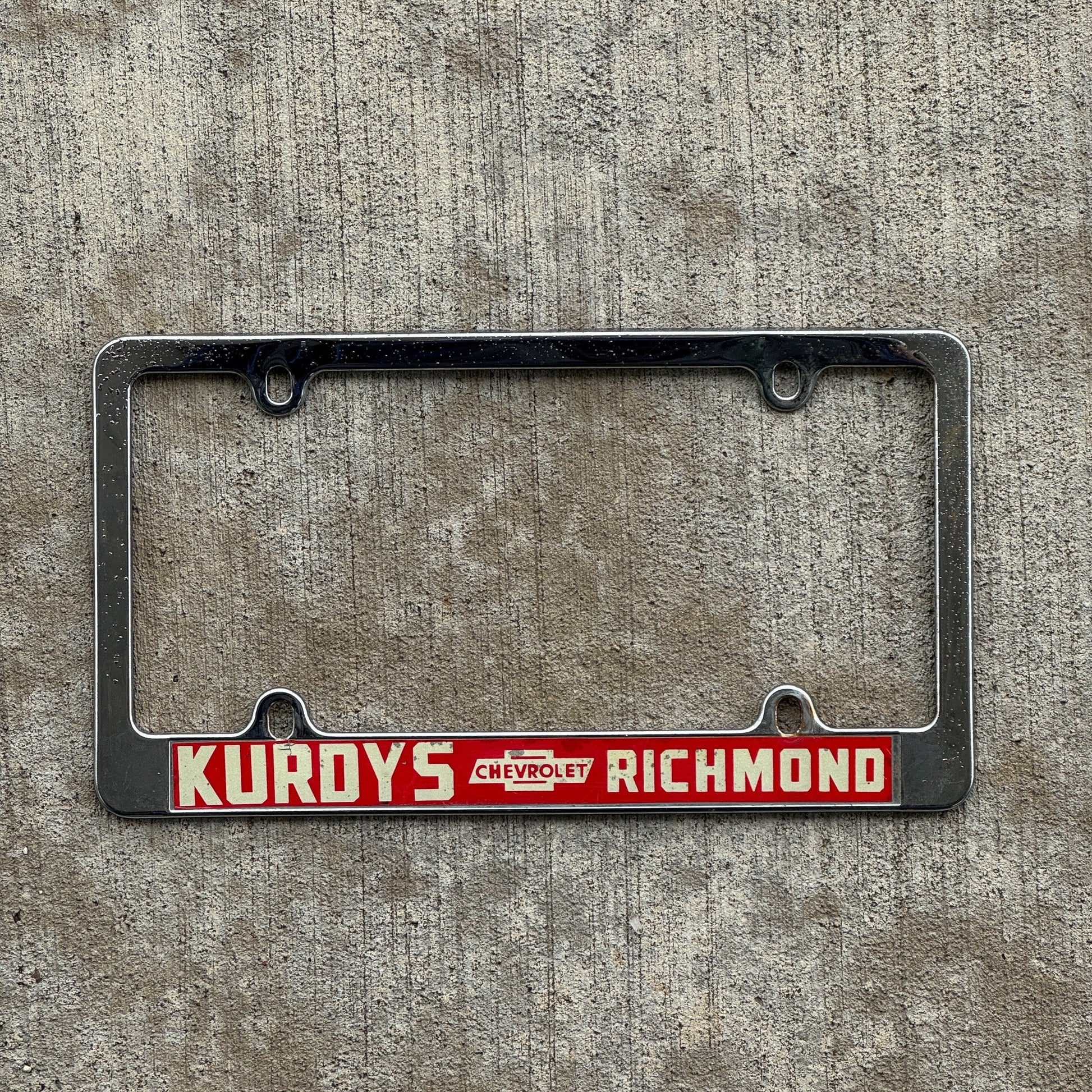 Photo of a 1970 Era Indiana License Plate Frame Auto Tag Garage Decor Vintage Richmond IN Kurdys Chevy with original patina