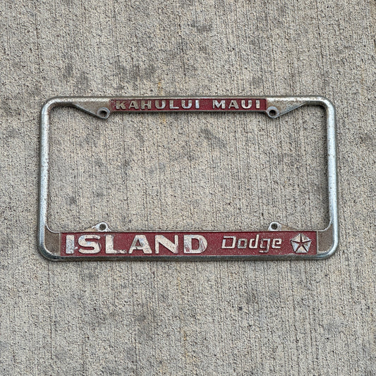 Photo of a 1970 Era Kahului Maui Hawaii License Plate Frame Auto Tag Garage Decor Vintage Island Dodge Dealer with original patina