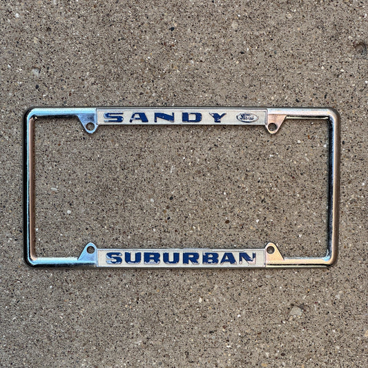 Photo of a 1970 Era Oregon License Plate Frame Auto Tag Garage Decor Vintage Ford Dealer Suburban Sandy OR Suburban Ford with original patina