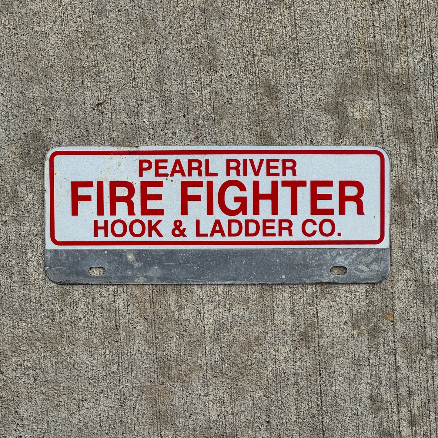Photo of a 1970 Era Pearl River Hook Ladder Co New York Fire Fighter License Plate Topper Auto Tag Garage Decor Vintage with original patina