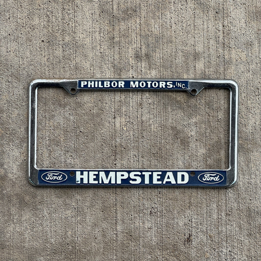 Photo of a 1970 Era Philbor Motors Hempstead New York License Plate Frame Auto Tag Garage Decor Vintage Ford Dealer with original patina
