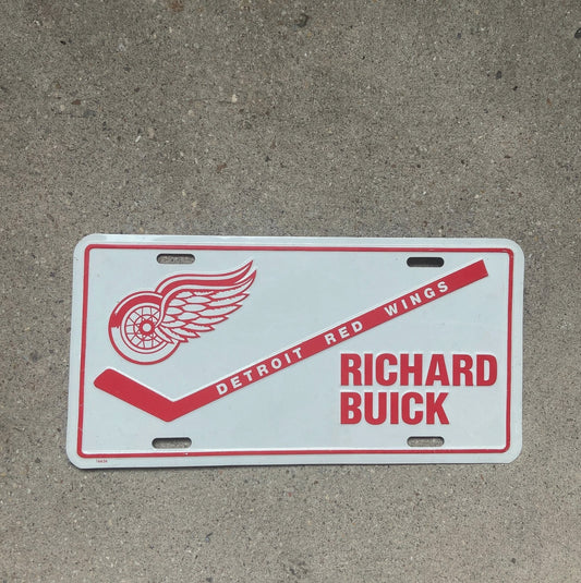 Photo of a 1970 Era Richard Buick Michigan Booster License Plate Auto Tag Garage Decor Vintage Detroit Red Wings NHL Hockey with original patina