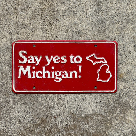 Photo of a 1970 Era Say Yes to Michigan Booster License Plate Auto Tag Garage Decor Vintage Metal with original patina