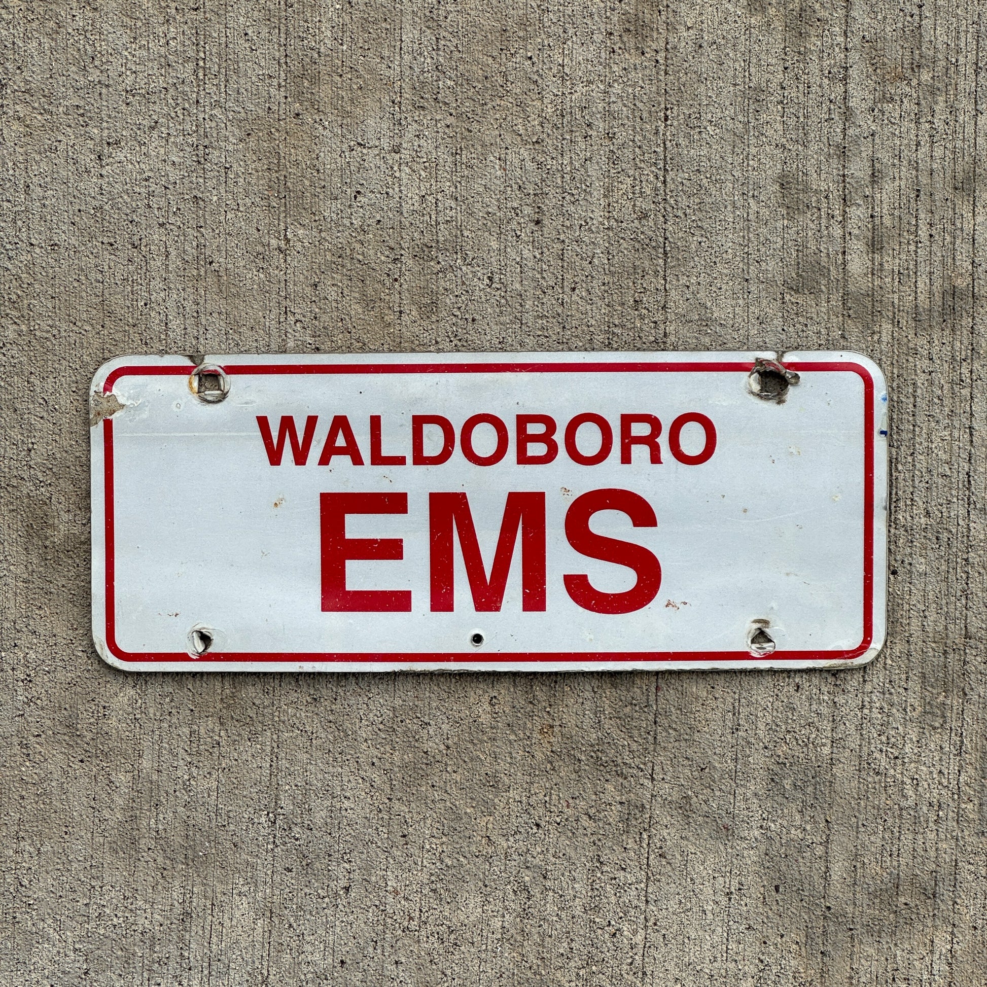 Photo of a 1970 Era Waldoboro Maine EMS License Plate Topper Auto Tag Garage Decor Vintage with original patina