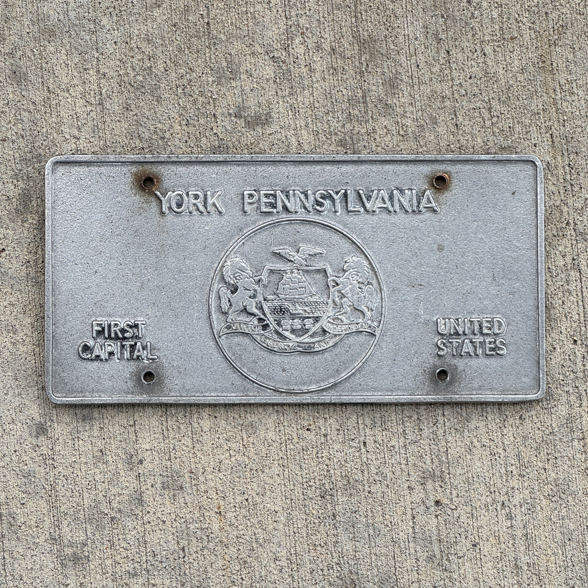 Photo of a 1970 Era York Pennsylvania Booster License Plate Auto Tag Garage Decor Vintage Cast Aluminum with original patina