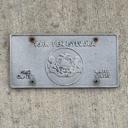 Photo of a 1970 Era York Pennsylvania Booster License Plate Auto Tag Garage Decor Vintage Cast Aluminum with original patina