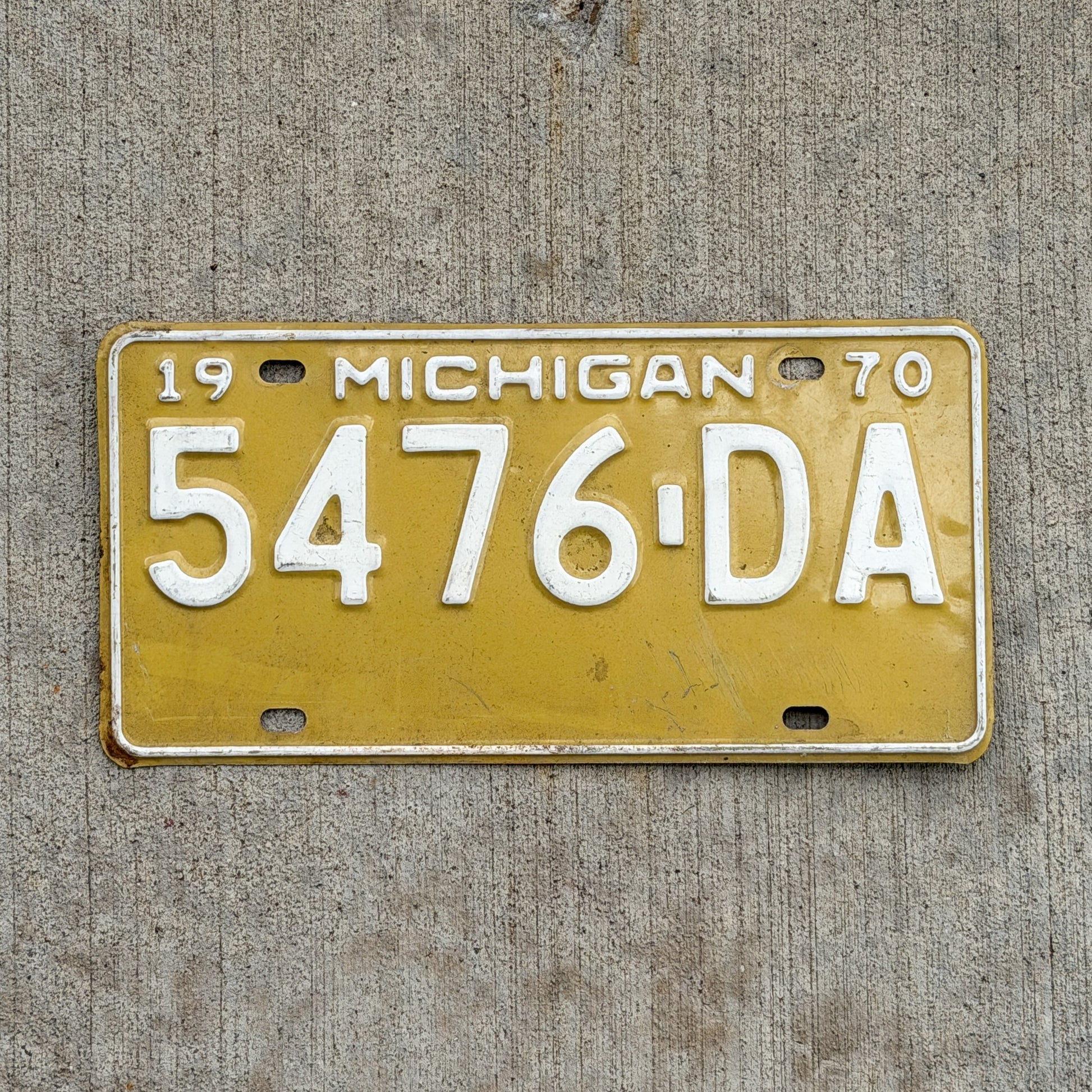 Photo of a 1970 Michigan Commercial License Plate Auto Tag Garage Decor Vintage 5476 DA with original patina