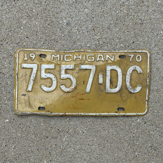 Photo of a 1970 Michigan Commercial License Plate Auto Tag Garage Decor Vintage 7557 DC with original patina