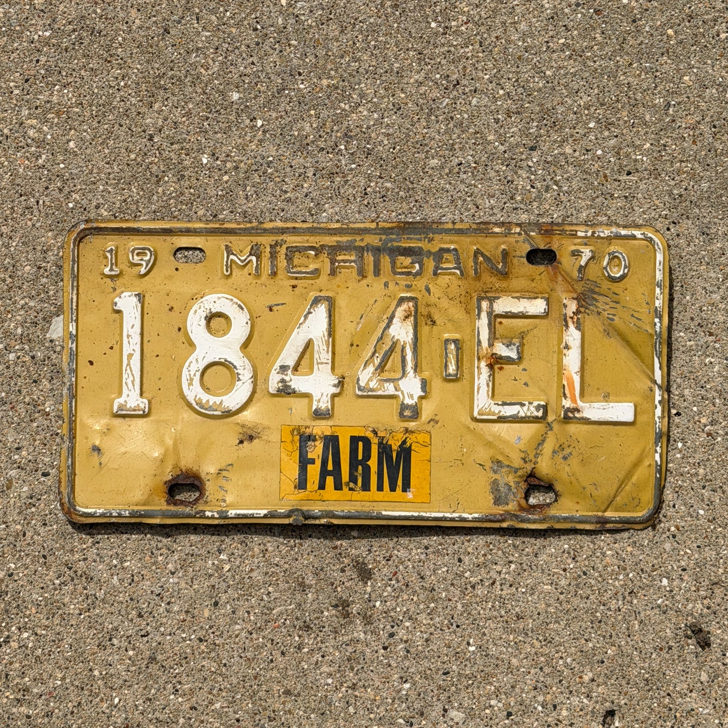 Photo of a 1970 Michigan Farm License Plate Auto Tag Garage Decor Vintage 1844 EL with original patina