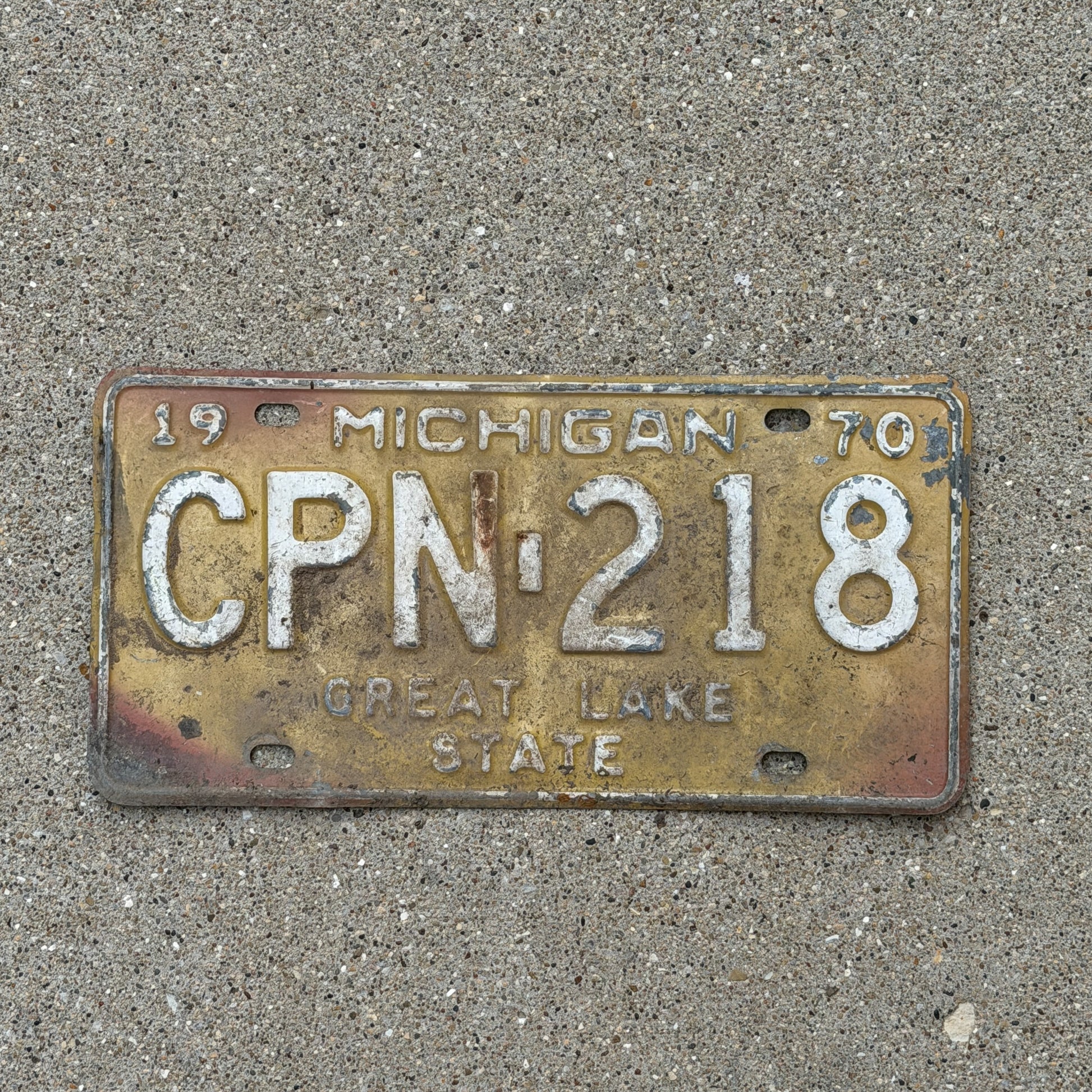 Photo of a 1970 Michigan License Plate Auto Tag 1 Vintage Garage CPN 218 with original patina