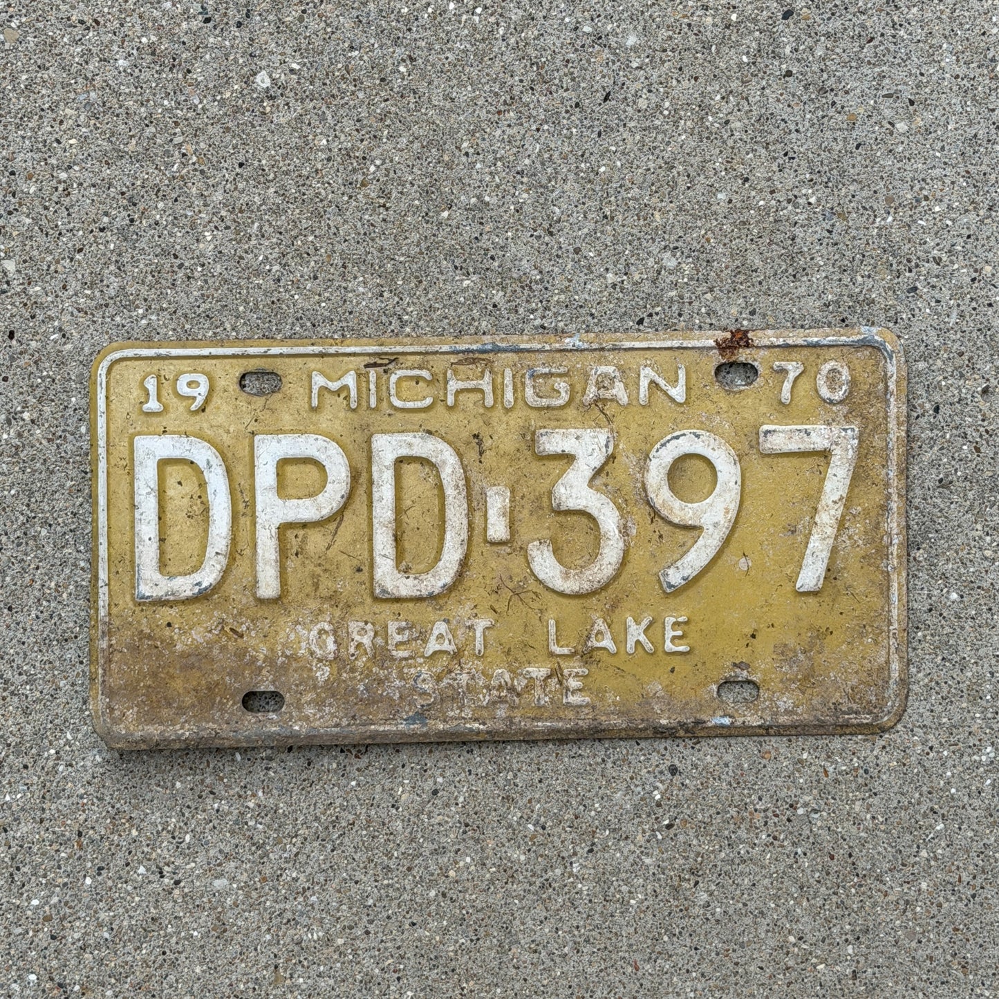 Photo of a 1970 Michigan License Plate Auto Tag 1 Vintage Garage DPD 397 with original patina