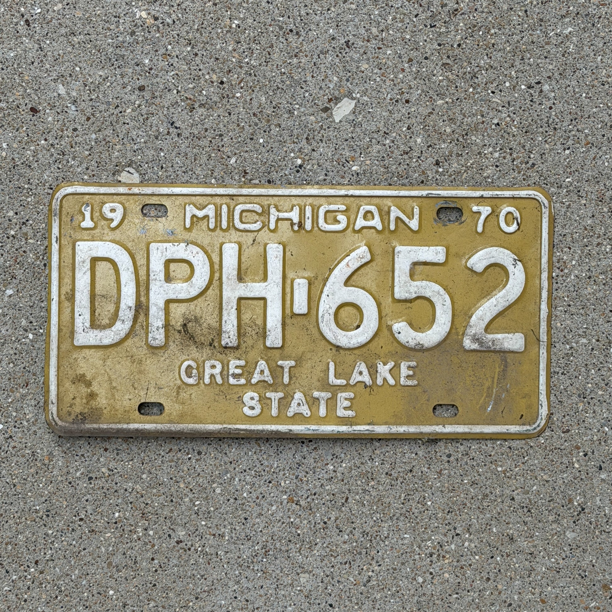 Photo of a 1970 Michigan License Plate Auto Tag 1 Vintage Garage DPH 652 with original patina