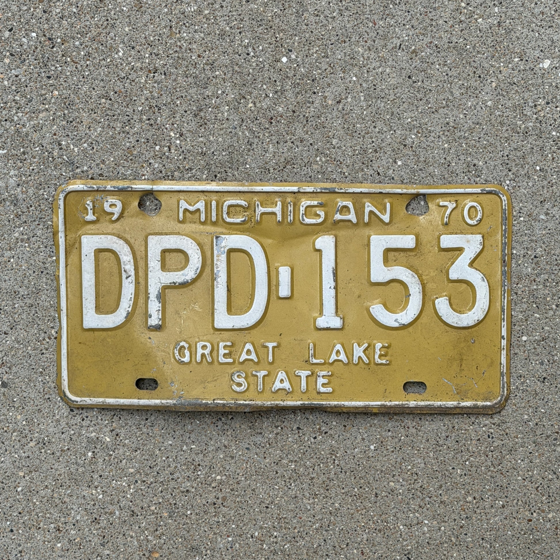 Photo of a 1970 Michigan License Plate Auto Tag 2 Vintage Garage DPD 153 with original patina