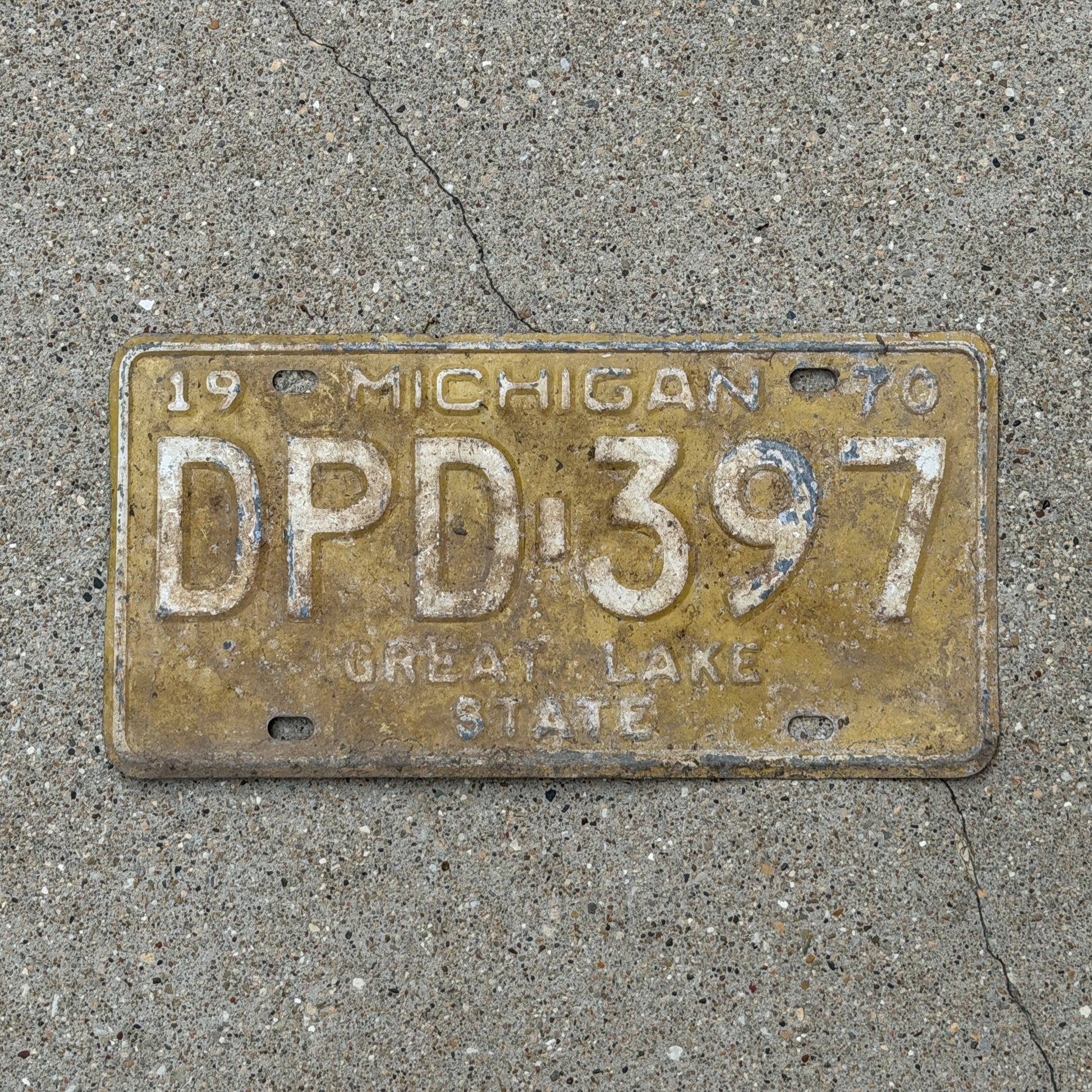 Photo of a 1970 Michigan License Plate Auto Tag 2 Vintage Garage DPD 397 with original patina