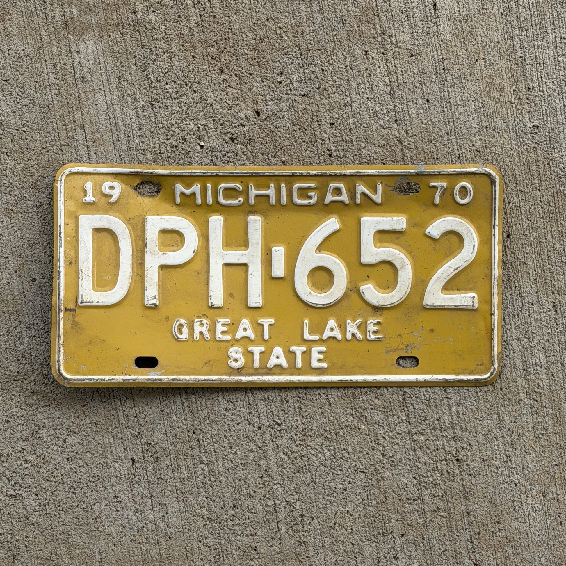 Photo of a 1970 Michigan License Plate Auto Tag 2 Vintage Garage DPH 652 with original patina
