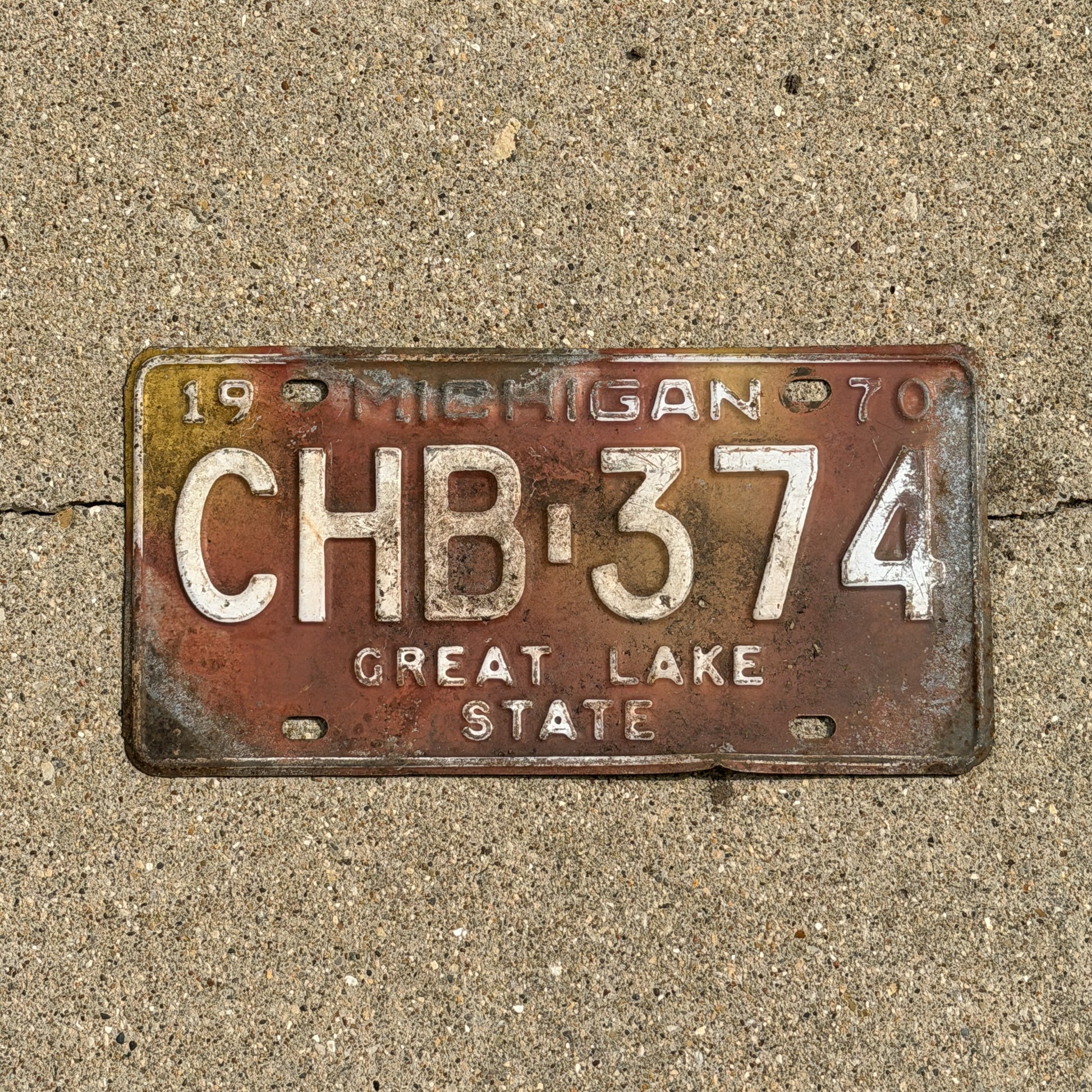 Photo of a 1970 Michigan License Plate Auto Tag Garage Decor Vintage CHB 374 with original patina