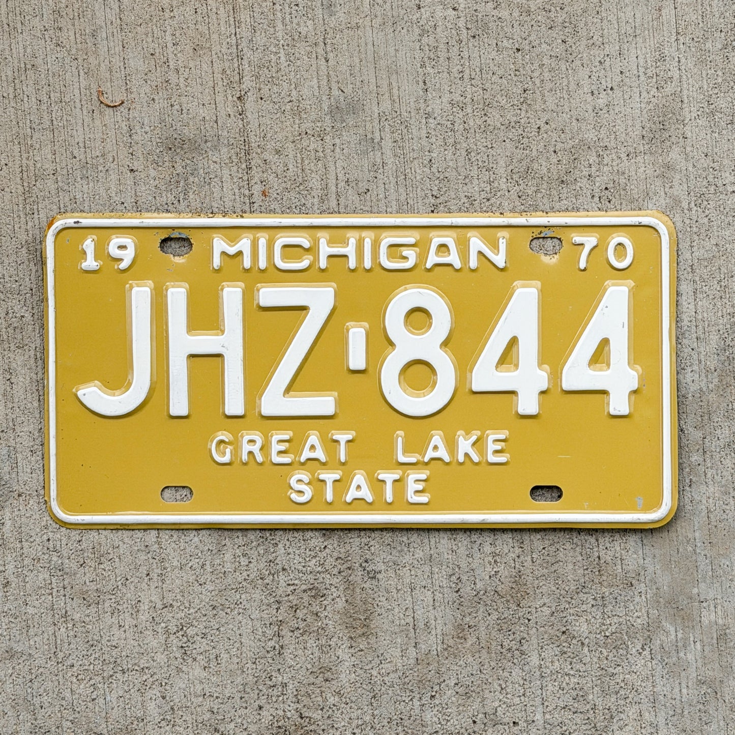 Photo of a 1970 Michigan License Plate Auto Tag Garage Decor Vintage JHZ 844 with original patina