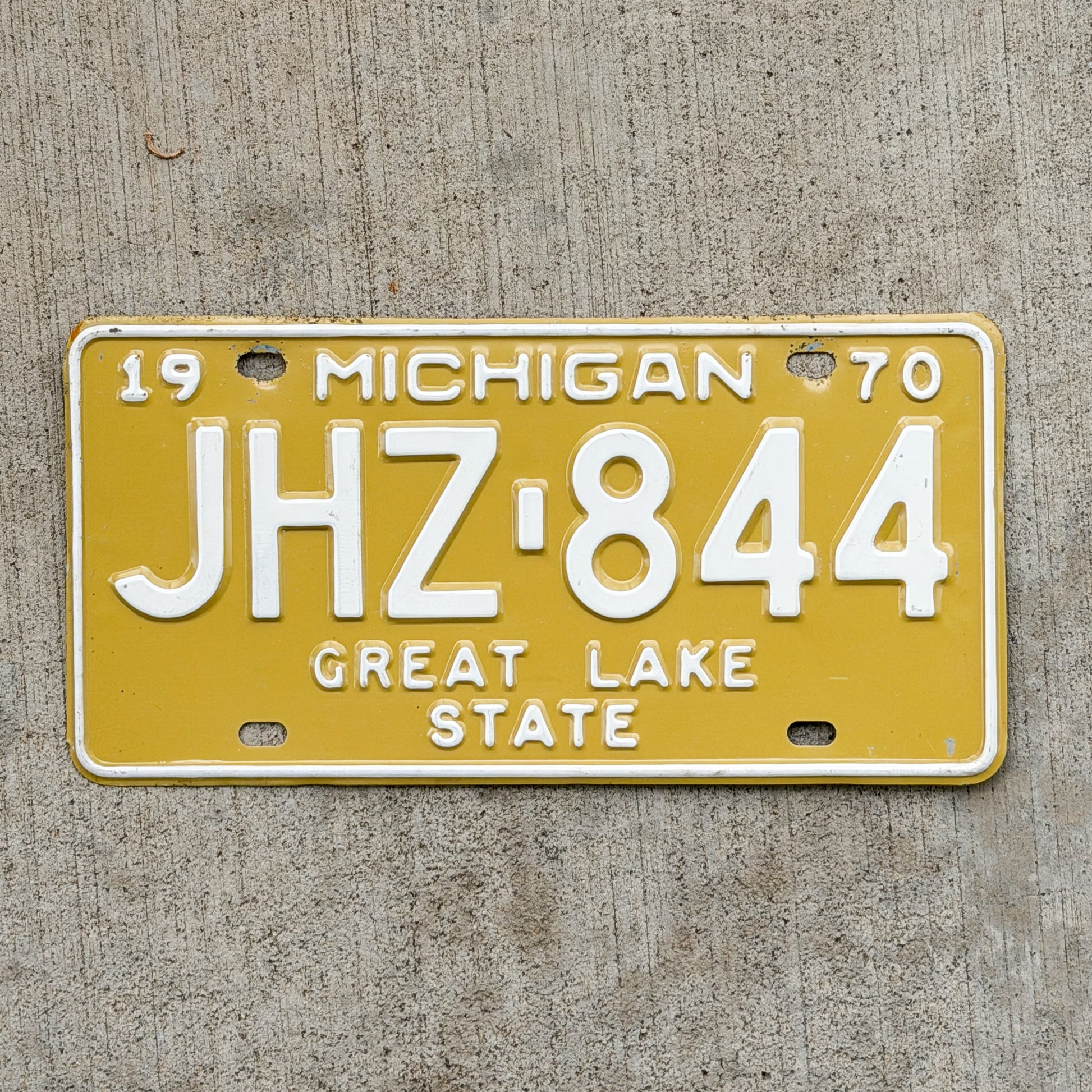 Photo of a 1970 Michigan License Plate Auto Tag Garage Decor Vintage JHZ 844 with original patina