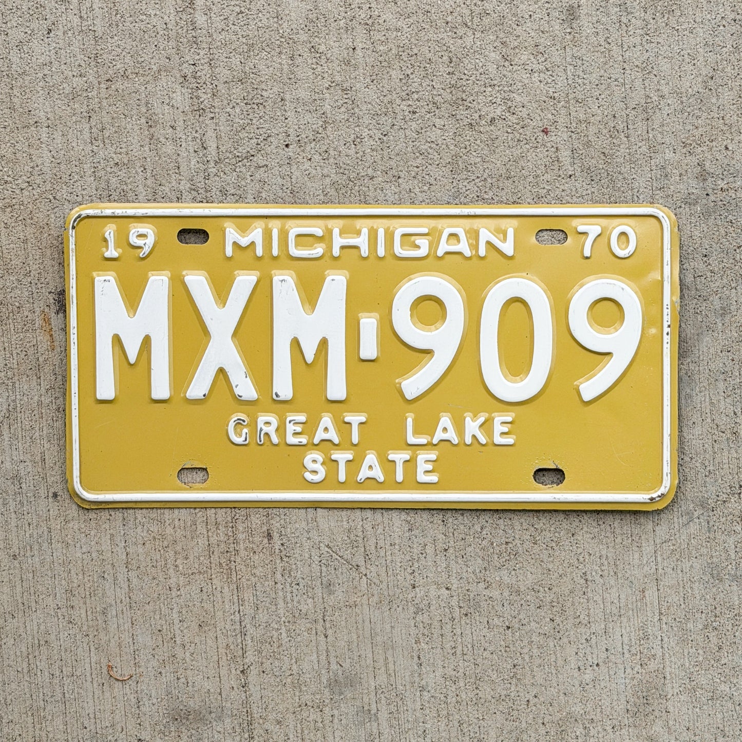 Photo of a 1970 Michigan License Plate Auto Tag Garage Decor Vintage MXM 909 with original patina