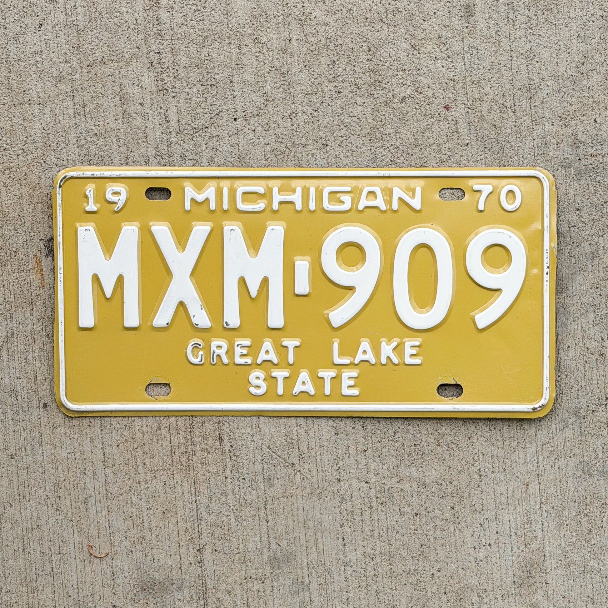Photo of a 1970 Michigan License Plate Auto Tag Garage Decor Vintage MXM 909 with original patina