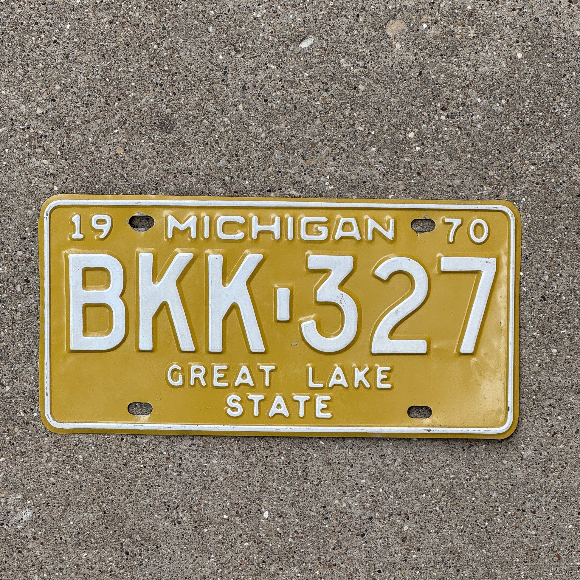 Photo of a 1970 Michigan License Plate Auto Tag Garage Decor Vintage Yellow BKK 327