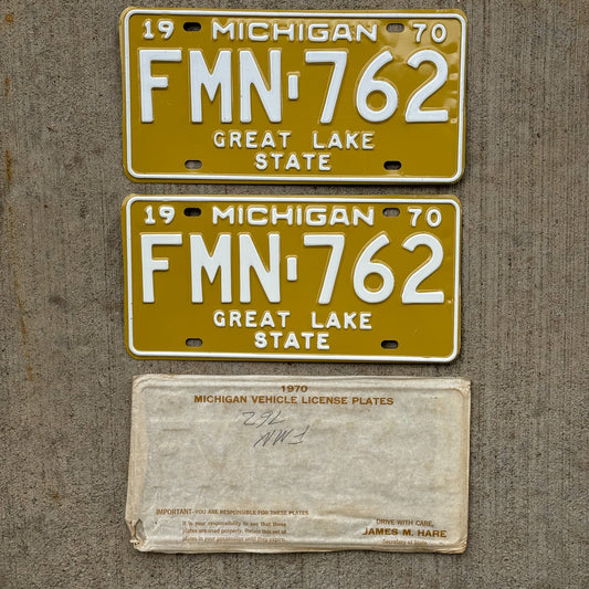 Photo of a 1970 Michigan License Plate Pair Auto Tag Garage Decor Vintage NOS with Original Mailing Envelope FMN 762