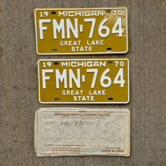 Photo of a 1970 Michigan License Plate Pair Auto Tag Garage Decor Vintage NOS with Original Mailing Envelope FMN 764