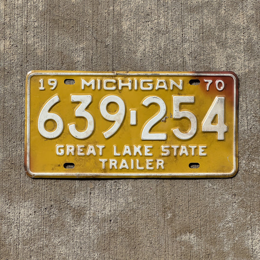 Photo of a 1970 Michigan Trailer License Plate Auto Tag Garage Decor Vintage 639 254 with original patina