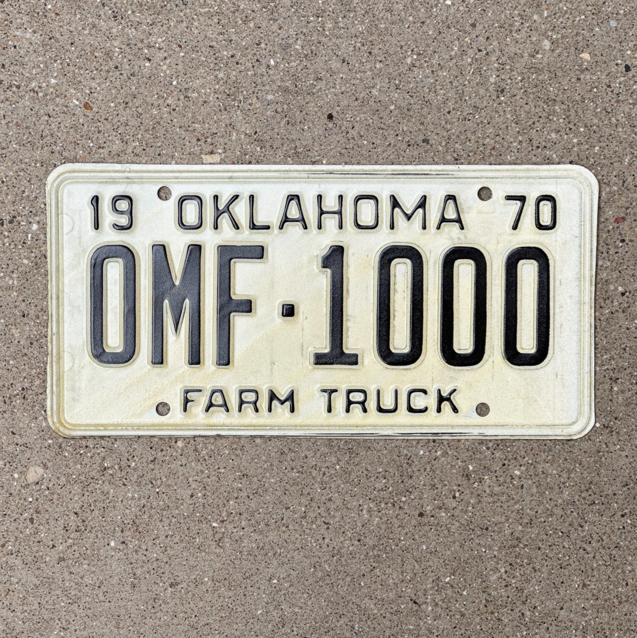 Photo of a 1970 Oklahoma Farm Truck License Plate Auto Tag Garage Decor Vintage Nice Number 0 MF 1000 with original patina