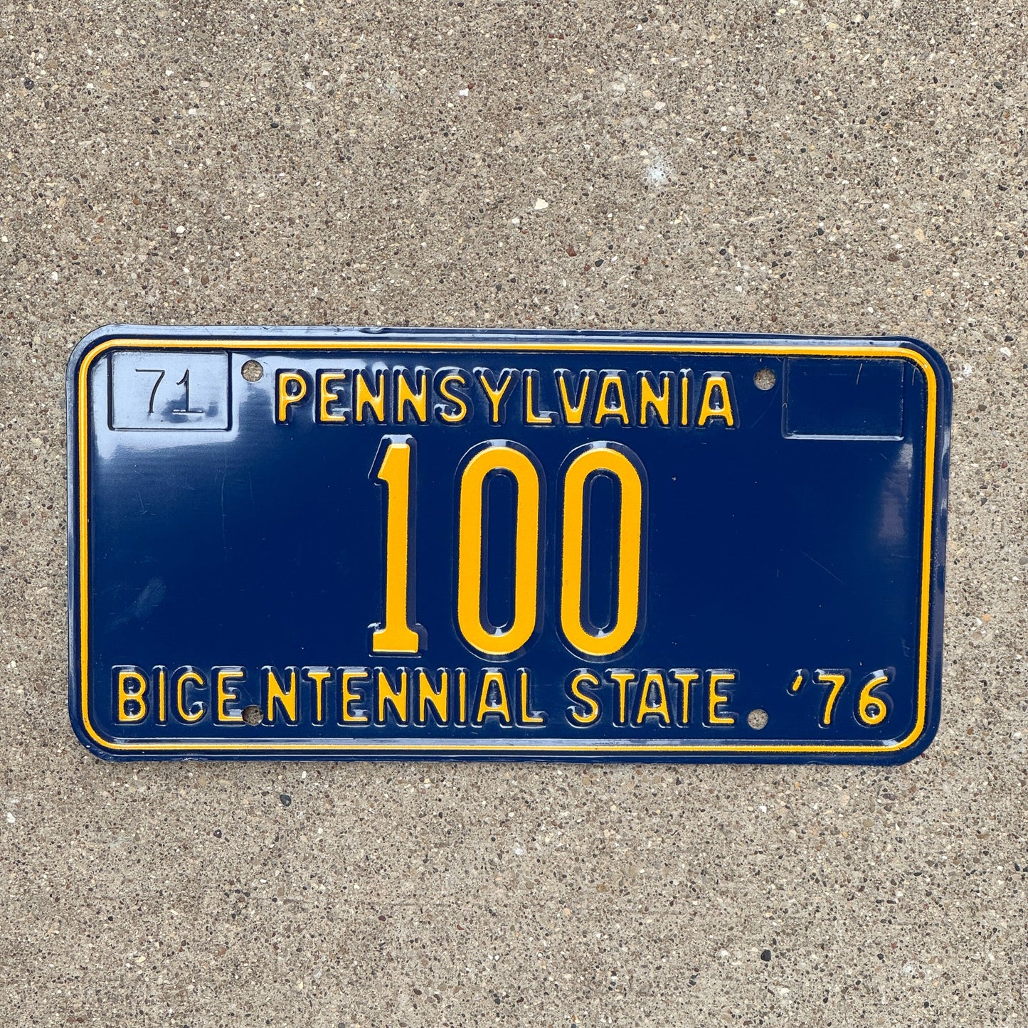Photo of a 1971 1976 Pennsylvania License Plate Auto Tag Garage Decor Vintage Bicentennial Low Number Three Digit 100 with original patina