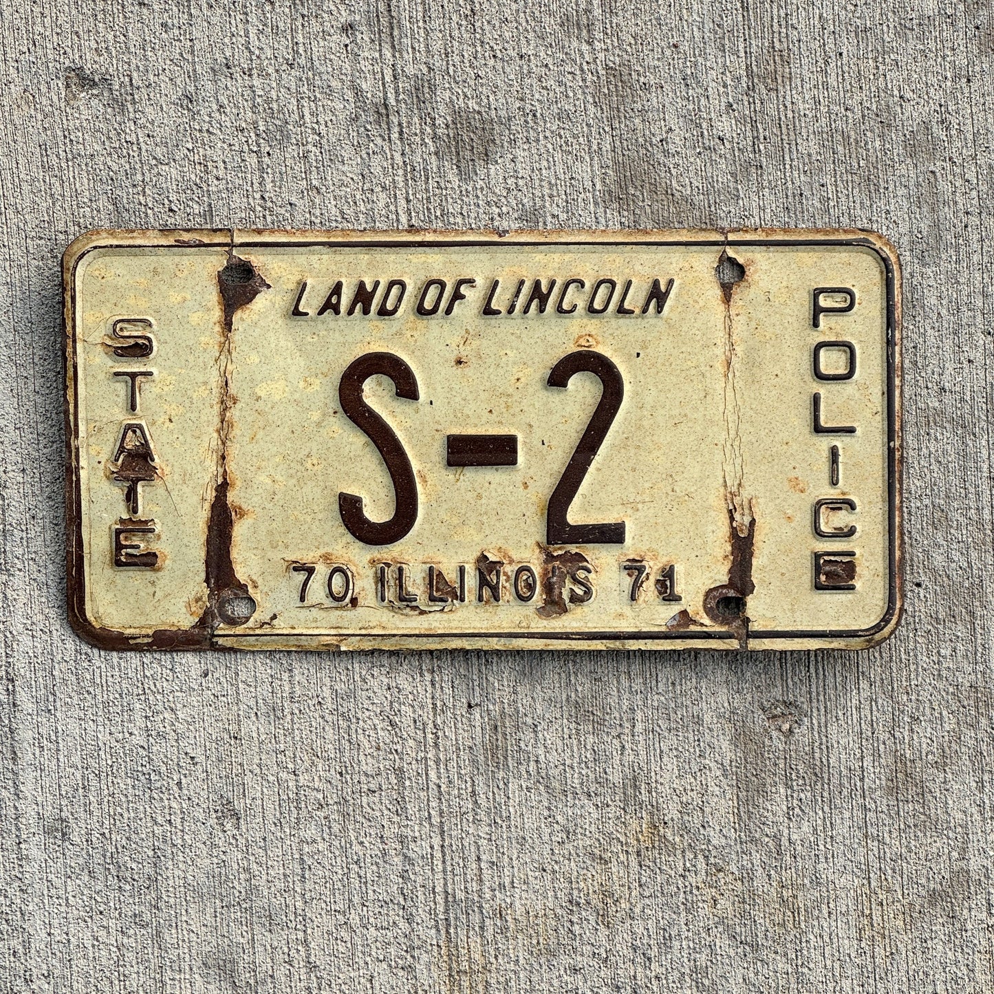 Photo of a 1971 Illinois Police License Plate Auto Tag Garage Decor Vintage Info and Education Officer Low Number Single Digit S 2 with original patina