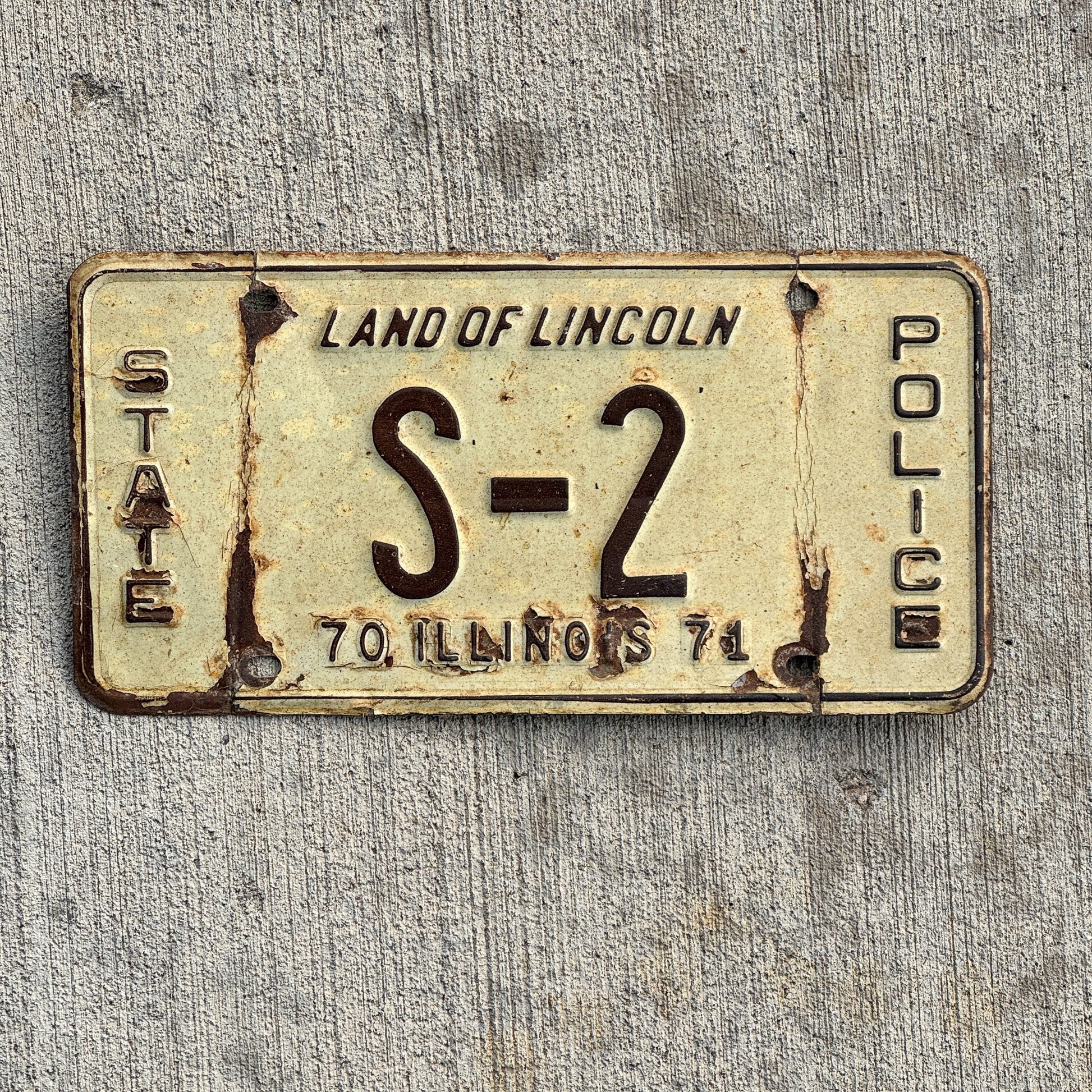 Photo of a 1971 Illinois Police License Plate Auto Tag Garage Decor Vintage Info and Education Officer Low Number Single Digit S 2 with original patina