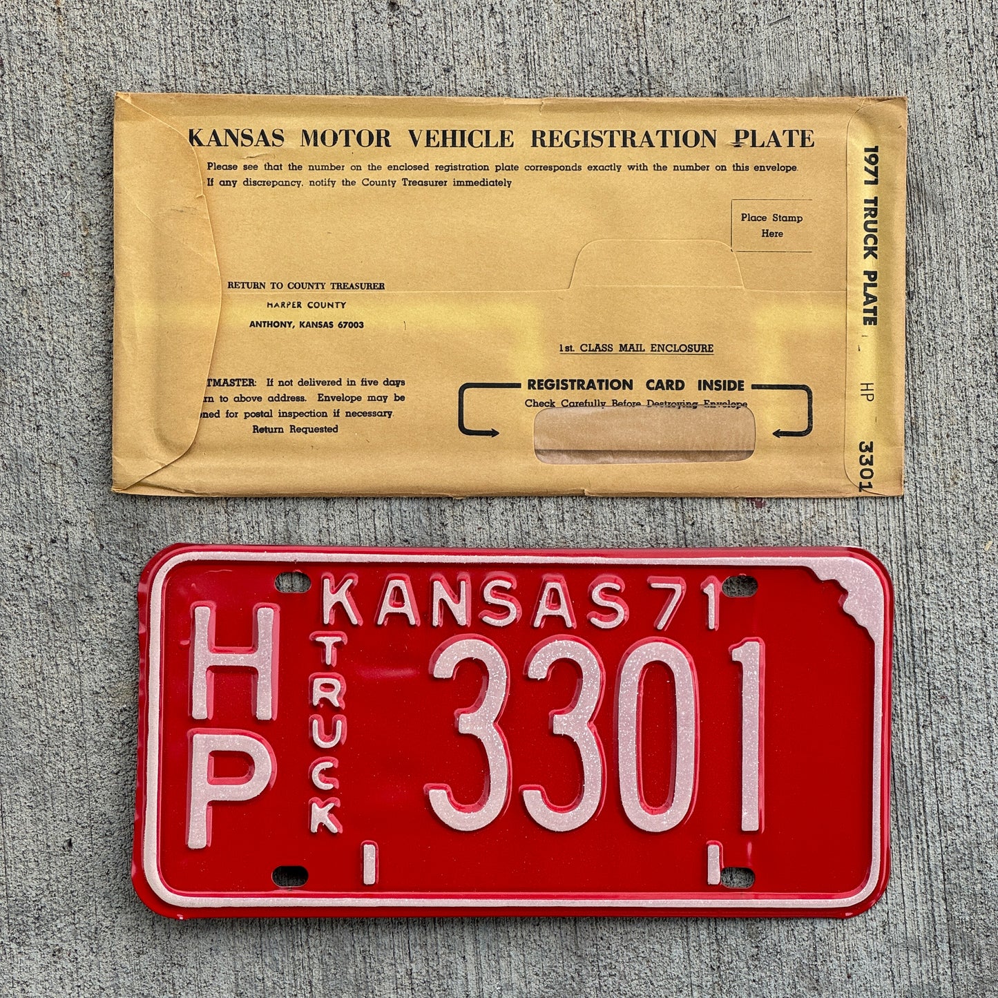 Photo of a 1971 Kansas Truck License Plate Auto Tag Garage Decor Vintage New Old Stock With Envelope HP 3301 with original patina