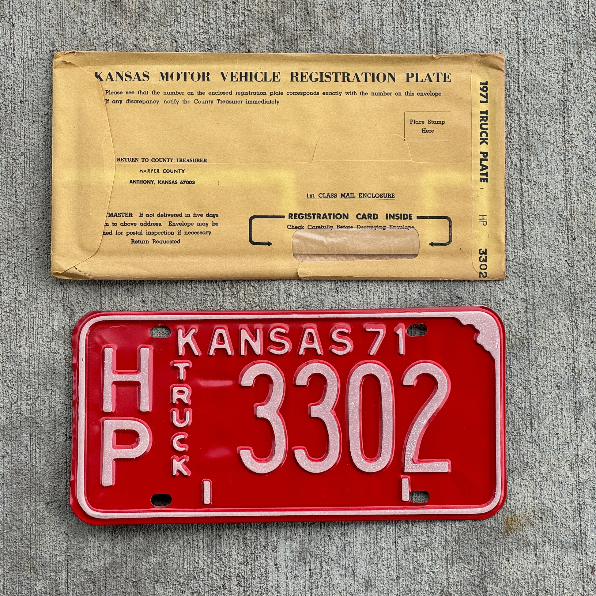 Photo of a 1971 Kansas Truck License Plate Auto Tag Garage Decor Vintage New Old Stock With Envelope HP 3302 with original patina